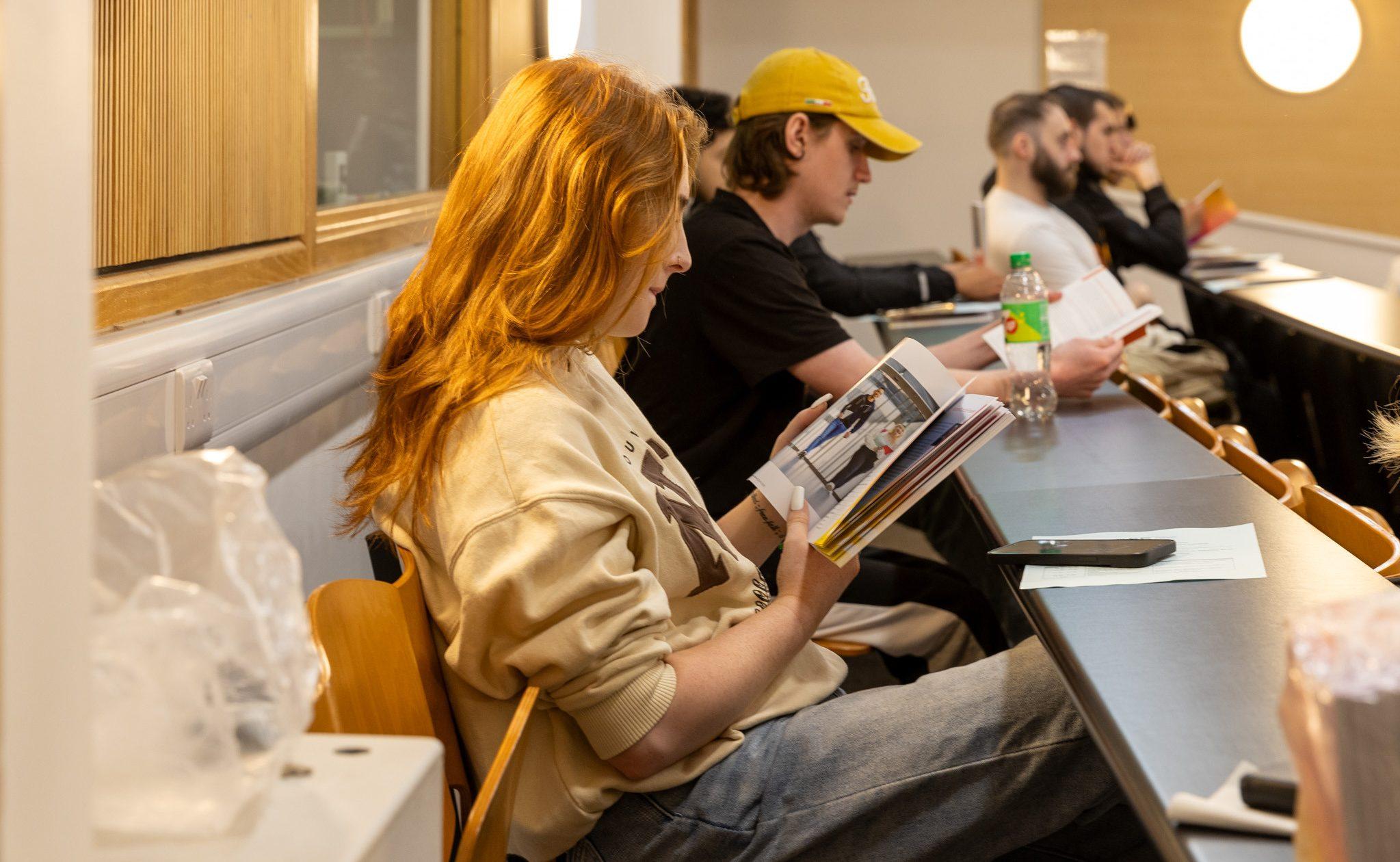 Students at the Progression Pathway Workshop reading the SETU student handbook