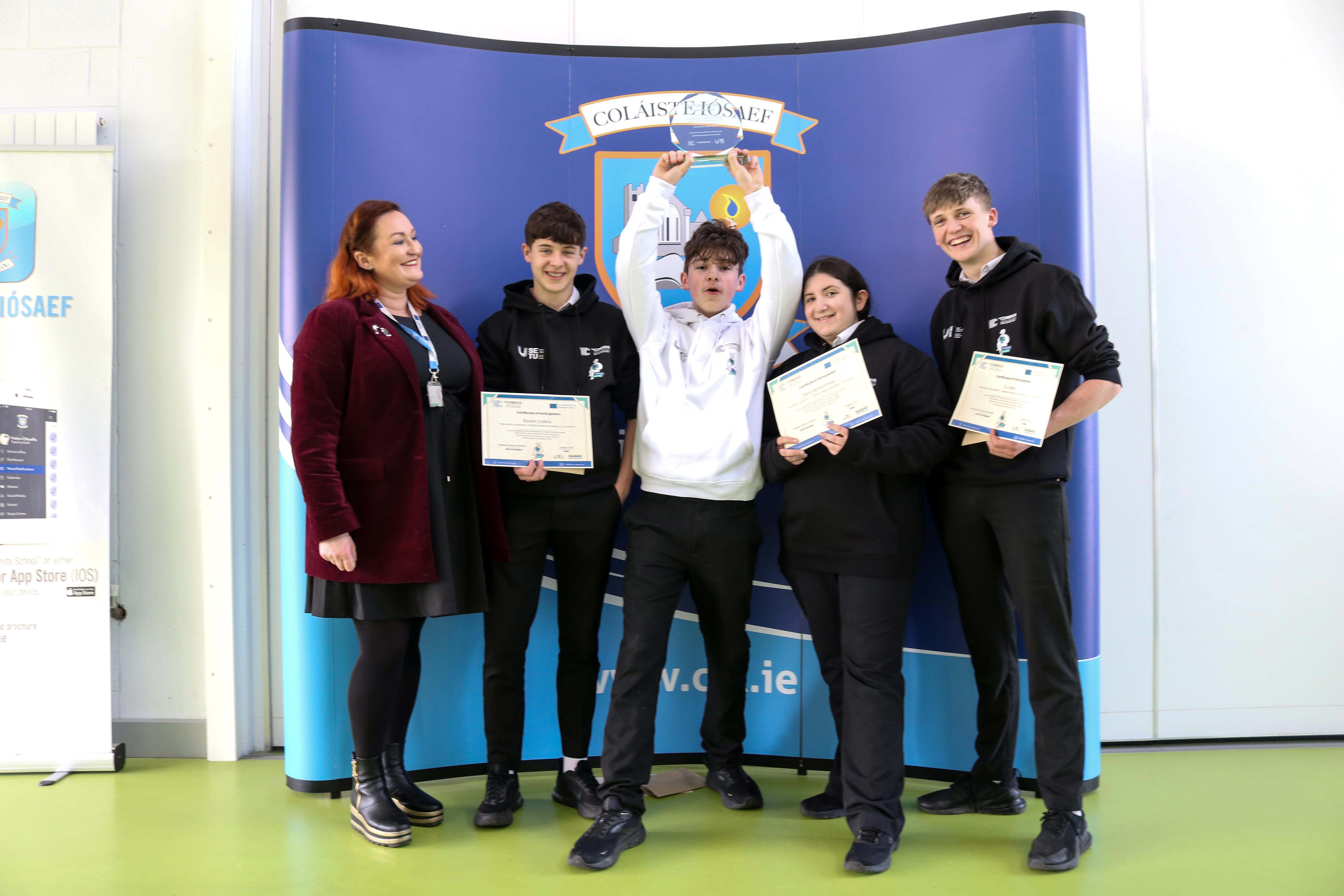Group of 4 secondary school students with trophy