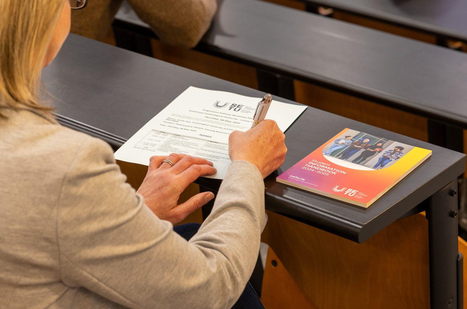 Attendee taking notes during Progression Pathway Workshop