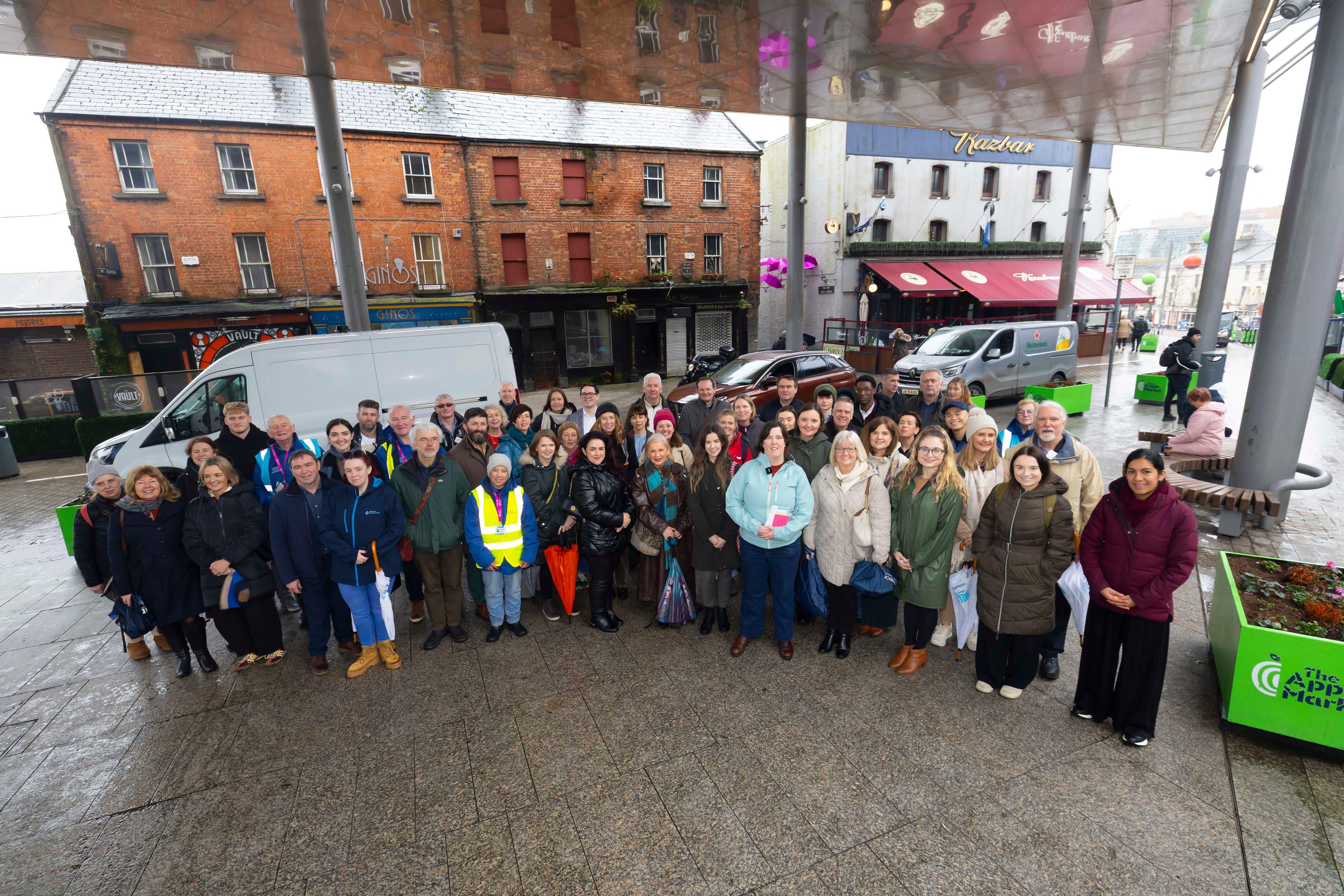Waterford Learning City Shared Island Exchange Visit in February 2026 walking tour of Waterford group photo in the apple market, Waterford