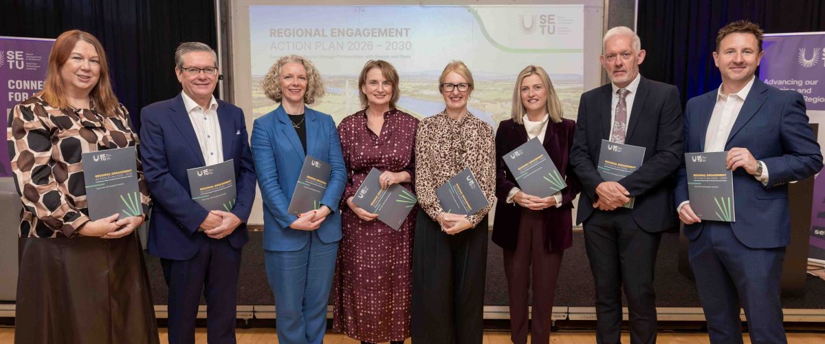 Large group with regional reports in hand