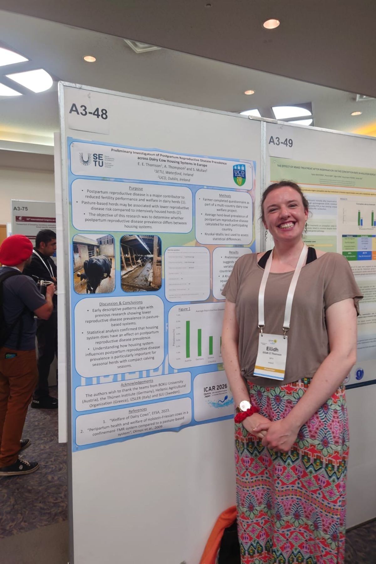 Female standing in front of her resarch poster