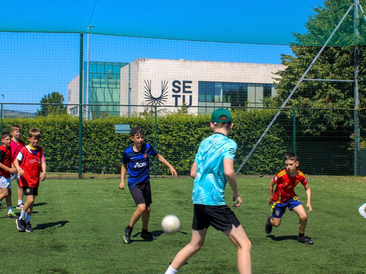 Children playing football in the sun as part of SETU's summer activity camps in Carlow.