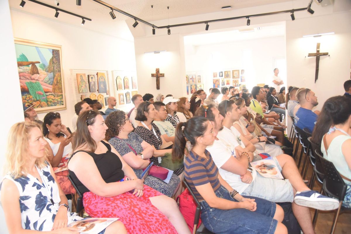 Group of people in a room listening to those presenting