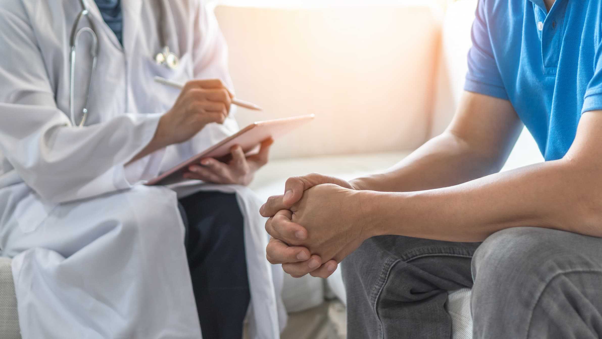 Doctor sitting down with man