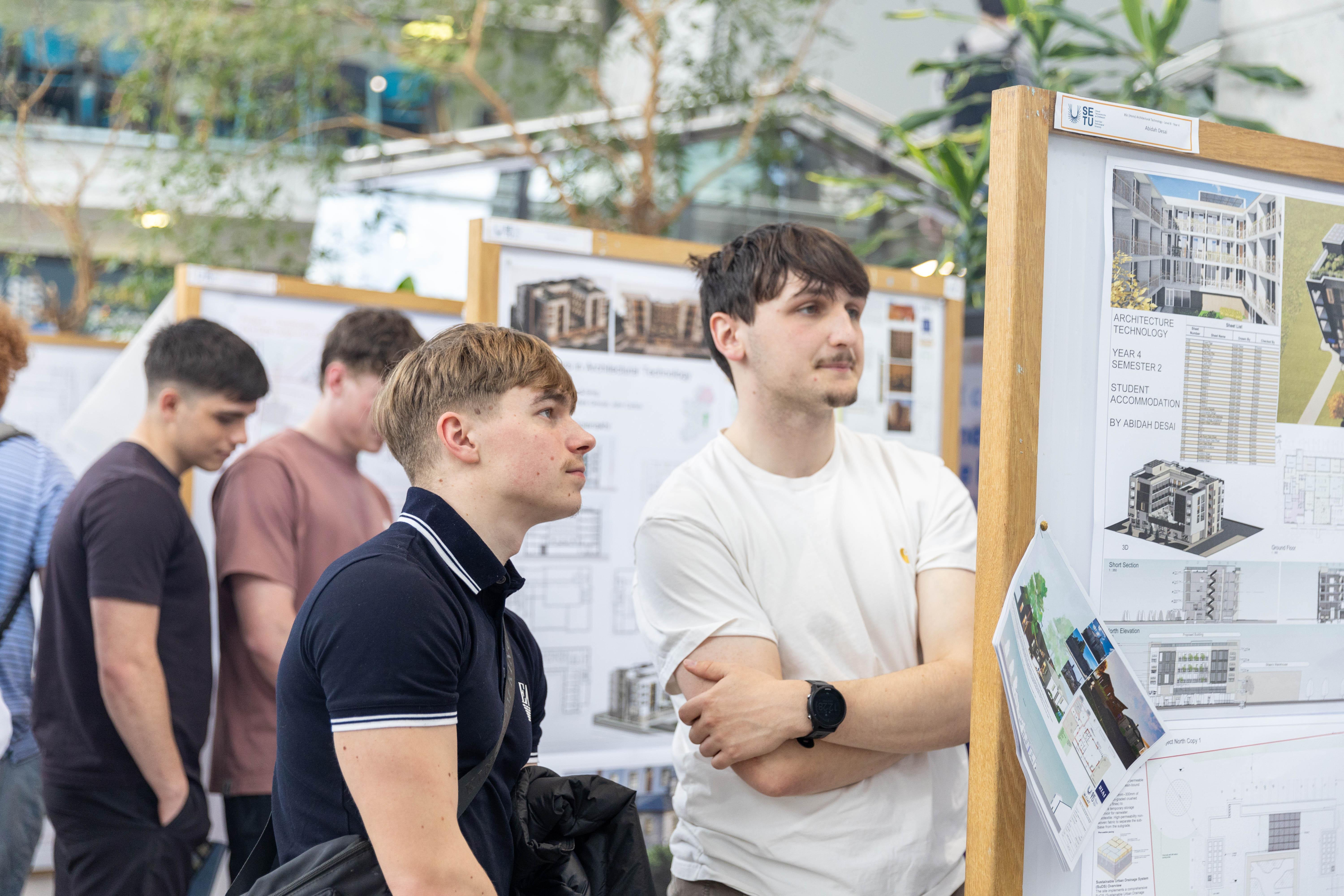attendees looking at students studio work