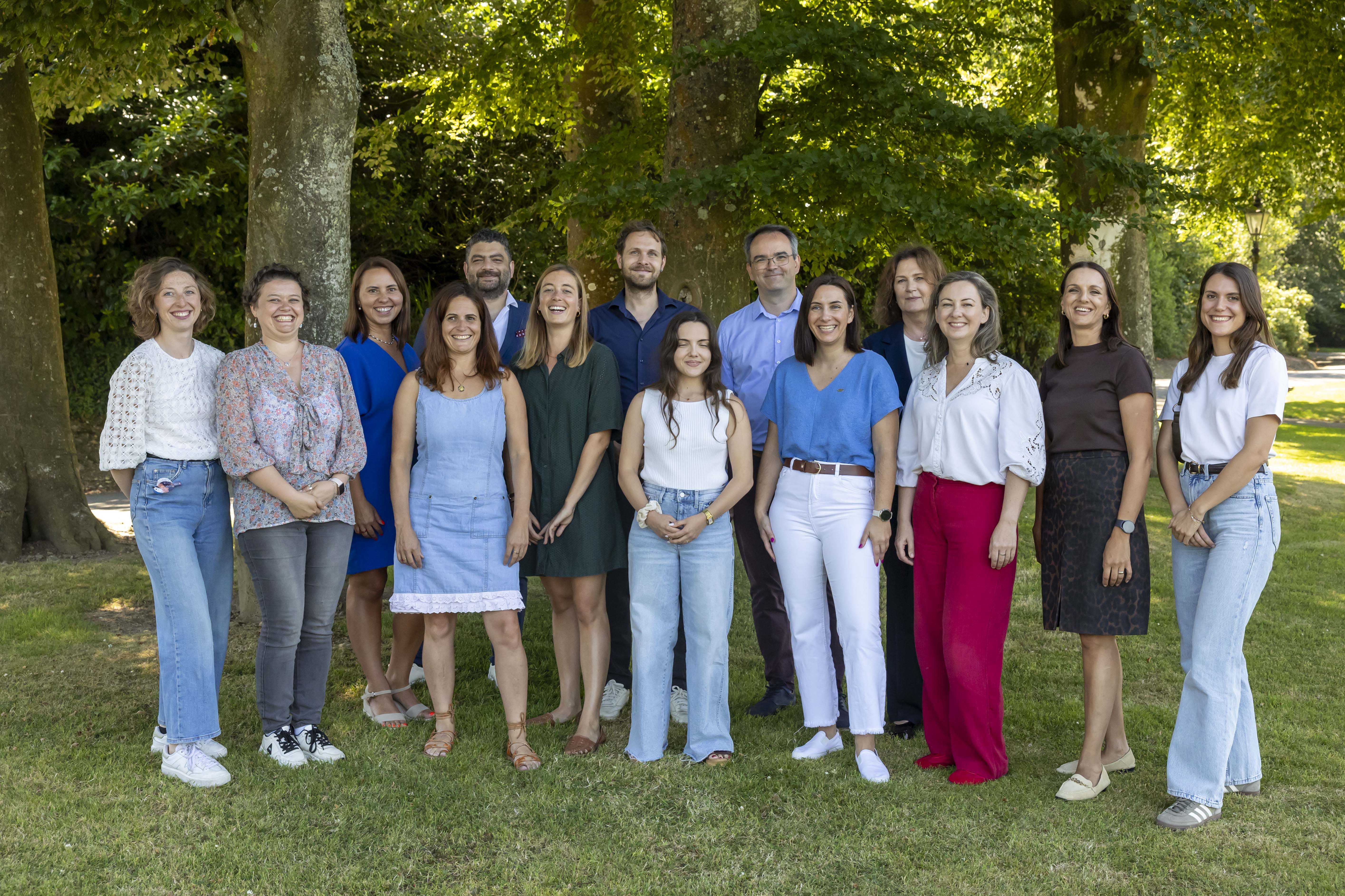 Group of people standing in front of trees