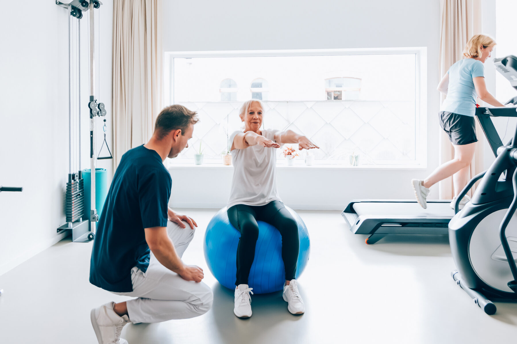 Woman exercising with male personal trainer