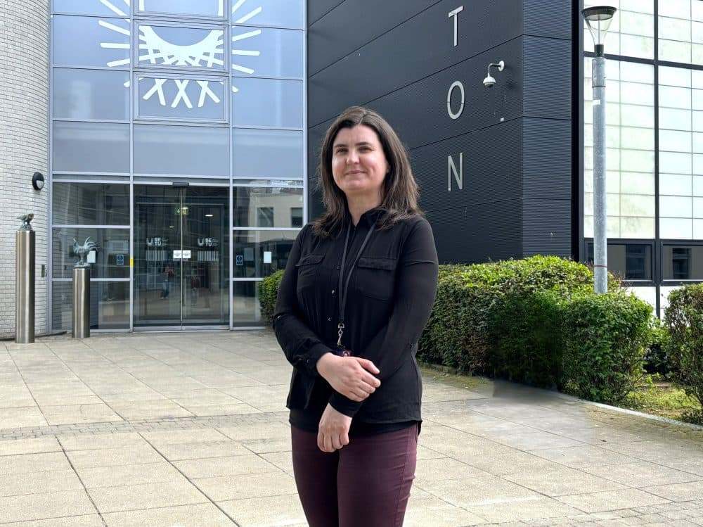 Muireann Prendergast standing in front of SETU's Walton IT building