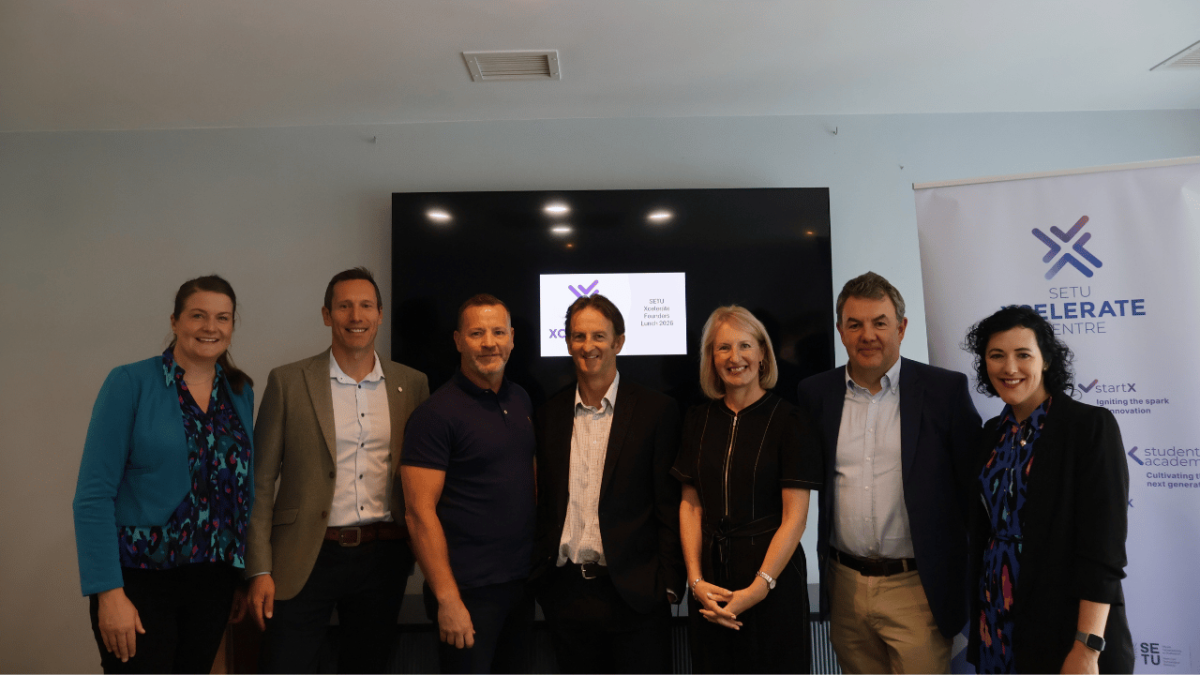 Xcelerate Clients and SETU staff stand in front of Screen