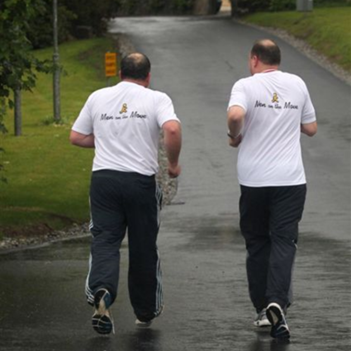 Two middle aged men running