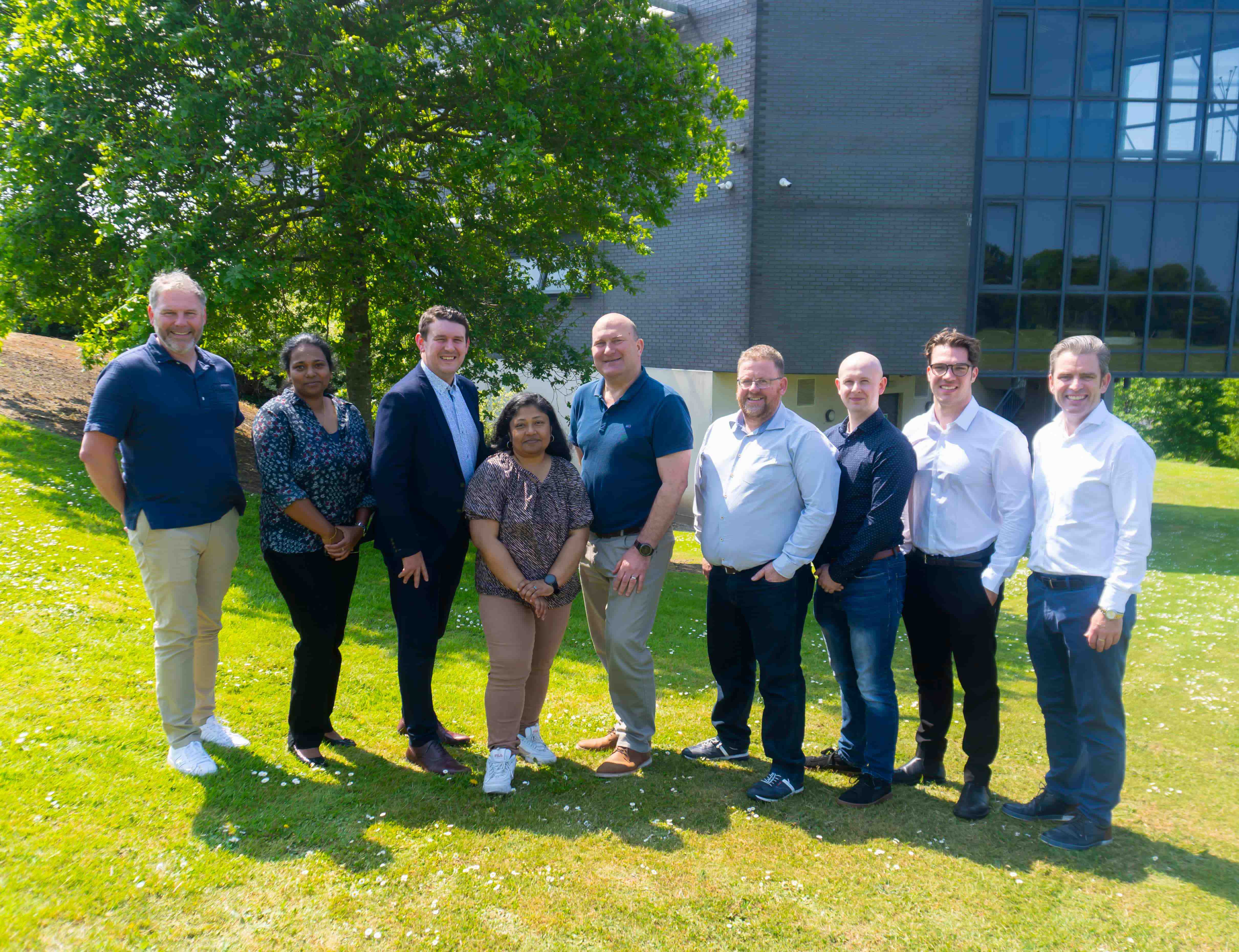 Members of the GreenSphere project team standing in the sunshine beside the NetLabs Building in SETU West Campus